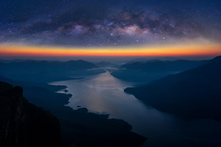 Landscape mountain scenery and water in the dam at sunrise with milky way on mountain pha daeng luang, Mae Ping National Park.の写真素材