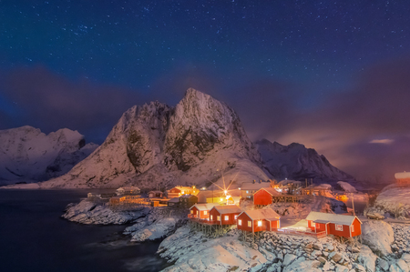 Beautiful view of night scenic fishing hut in the Hamnoy and Lilandstinden mountain peak Lofoten Islands archipelago winter scenery, Beautiful mountain landscape in winter Reine Norway, Scandinavia.の写真素材