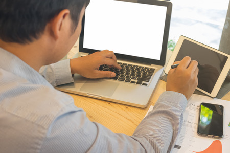 Asian businessman using laptop computers and gadgets in cafes, they enter information into laptops for web search, browsing / soft focus images.の写真素材