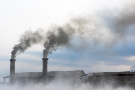Air pollution with black smoke from chimneys from factories that are not environmentally friendly.の写真素材