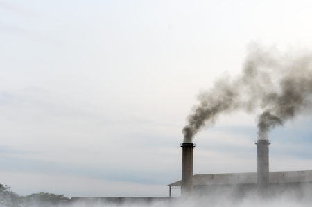 Air pollution with black smoke from chimneys from factories that are not environmentally friendly.の写真素材