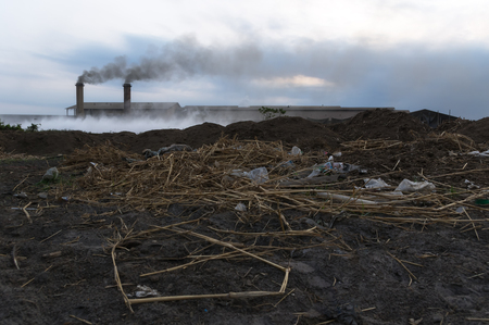 industrial waste and air pollution with black smoke from chimneys.の写真素材