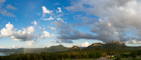 Beautiful panorama mountainous landscape with rainbow. In the sky there is a rainbow after rain, viewpoint mae moh power plant Lampang Thailand.の写真素材