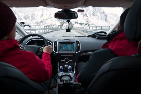 Two guy driving on the Highway using GPS, Driving car in winter inside view.の写真素材