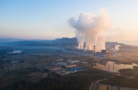 Aerial view of coal-fired power plants In the morning there was a smoke group caused by steam above the factory.の写真素材