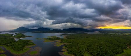 Landscape Aerial view panoramic at sunset with rainstorm above mountain in Mae Chang Reservoir, Mae Moh, Lampang, Thailand, Drone.の写真素材
