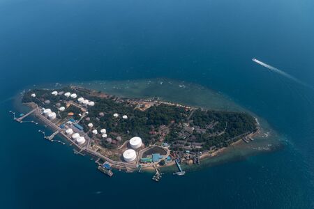 Beautiful aerial view above the clouds, below is the bay, with many cargo boats near Changi Airport, Singapore. Soft focus.の写真素材