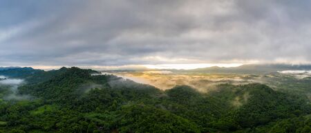 Beautifully Landscape Aerial view panoramic at sunrise with fog above mountain in Mae Moh, Lampang, Thailand, Drone.の写真素材