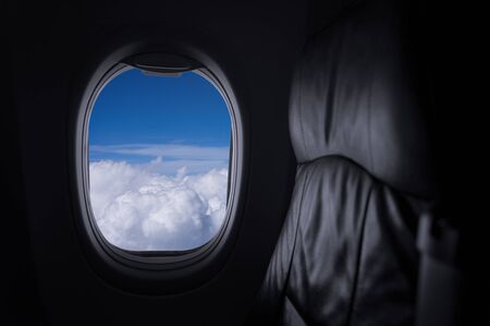 Window View From Passenger Seat On Commercial Airplane with blue sky, Concept of travel and air transportation.の写真素材