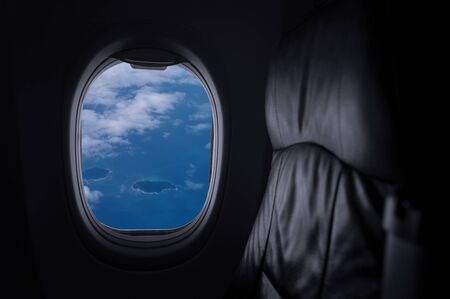 Window View From Passenger Seat On Commercial Airplane with blue sky, Concept of travel and air transportation.の写真素材