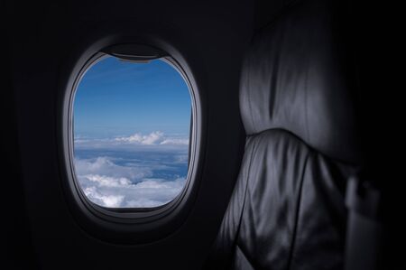 Window View From Passenger Seat On Commercial Airplane with blue sky, Concept of travel and air transportation.の写真素材