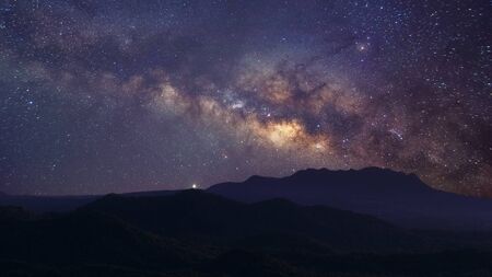 Milky way galaxy at mountain with stars and space dust in the universe, long speed exposure, Night landscape with colorful Milky Way, Starry sky with hills, Beautiful Universe, Space background.の写真素材
