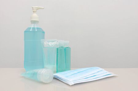 Coronavirus Prevention Equipment, Medical Surgical Mask Hand sanitizer and Medical gloves on the white table, blank space for adding a campaign message to prevent the spread of disease to others.の写真素材