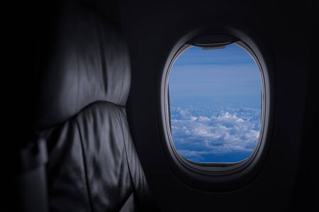 Window View From Passenger Seat On Commercial Airplane with blue sky, Concept of travel and air transportation.の写真素材