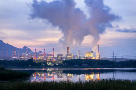 Steam fumes above the coal power plant in large area The machine is working to generate electricity the beautiful morning with fog and clouds, air pollution.の写真素材