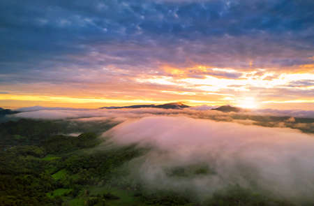 Beautiful Aerial view sunrise over the mountain range at the north of thailand, Beauty rainforest landscape with fog in morningの写真素材