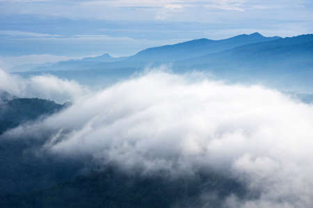 Aerial view Beautiful of morning scenery sea of cloud and the fog flows on high mountains.の写真素材