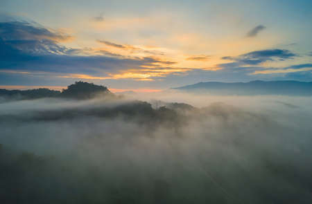 Aerial view Beautiful of morning scenery sea of cloud and the fog flows on high mountains.の写真素材