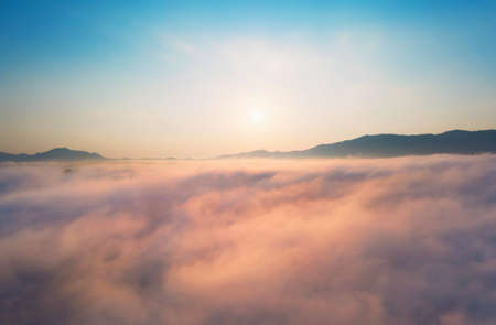 Aerial view Beautiful of morning scenery sea of cloud and the fog flows on high mountains.の写真素材