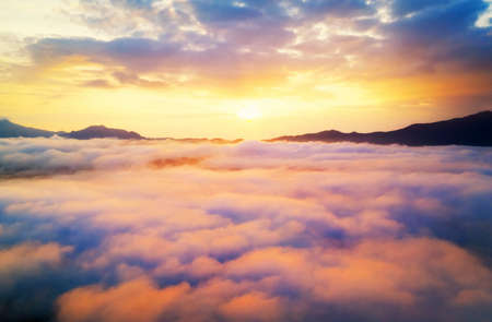 Aerial view Beautiful of morning scenery sea of cloud and the fog flows on high mountains.の写真素材
