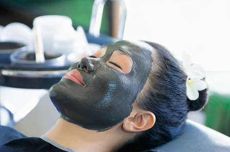 Beautiful asian woman Facial mask with natural mud to nourish the skin for beauty. Phu Klon, Mae Hong Son Province, Thailand.の写真素材