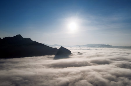 Aerial view Beautiful of morning scenery sea of cloud and the fog flows on high mountains.の写真素材