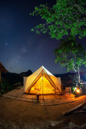 Bell tent camping white in the midst of nature and the Milky Way at night.の写真素材