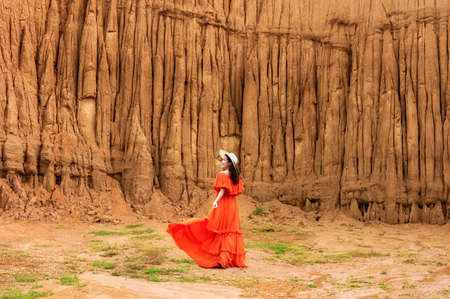 Women and landscape of soil textures eroded sandstone pillars, columns and cliffs, natural erosion of water and wind, Sao Din Na Noi, Hom Chom, Khok Suea at sri nan national park in Nan Provinceの写真素材