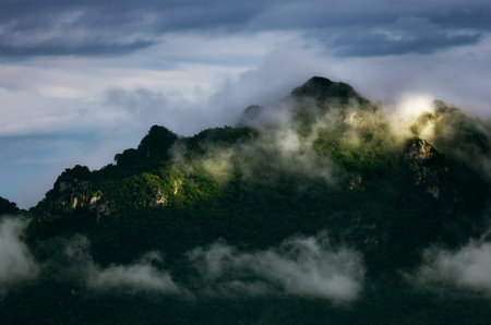 Beautiful Landscape in the morning time during sunrise with fog above the mountain, White fluffy clouds moving softly on cloudy, Pang puay, Mae moh, Lampang, Thailand.の写真素材