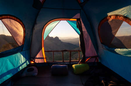 View from inside the tent looking out into nature morning forest and mountains.の写真素材
