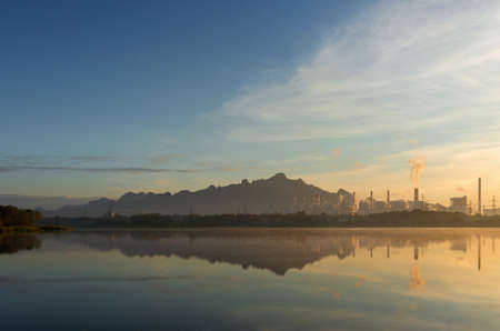 Coal power plant and water reflection in the morning among the mountains and lakes. Mae Moh, Lampang, Thailand.の写真素材