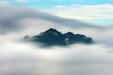 Beautiful long exposure Landscape in the morning time during sunrise with fog above the mountain, White fluffy clouds moving softly on cloudy, Pang puay Mae moh Lampang, Thailand.の写真素材
