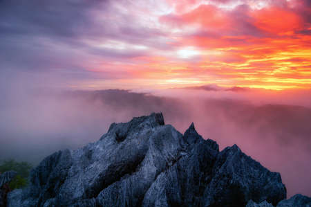 Aerial view Beautiful on rock of morning scenery Golden light sunrise And the mist flows on high mountains, Wonder fog. pang puay, Mae moh, Lampang, Thailand.の写真素材