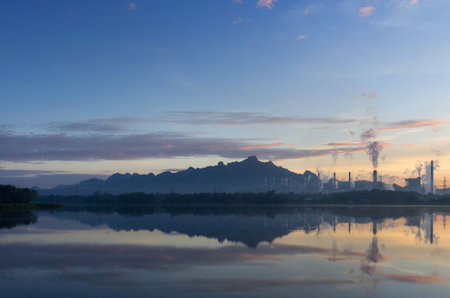 Coal power plant and water reflection in the morning among the mountains and lakes. Mae Moh, Lampang, Thailand.の写真素材