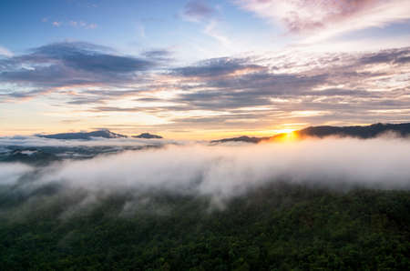 Aerial view beautiful sea of fog in the morning forest with green mountains. Pang Puay, Mae Moh, Lampang, Thailand.の写真素材