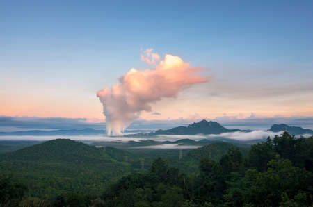 Beautiful sea of fog in the mountains, high voltage pole and steam from the coal power plant in the morning sunrise . Mae moh, Lampang, Thailand. Energy and environment concept .の写真素材