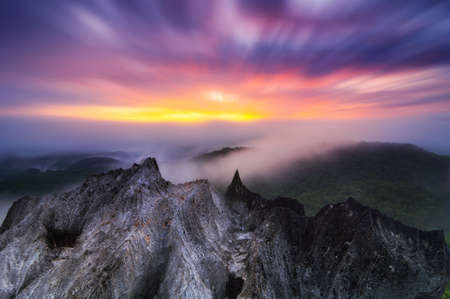 Aerial view Beautiful on rock of morning scenery Golden light sunrise And the mist flows on high mountains, Wonder fog. pang puay, Mae moh, Lampang, Thailand. Long exposure.の写真素材