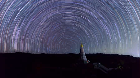 Star trails moving over a sacred temple at Doi Inthanon National Park, Chiang Mai, Thailand.の写真素材