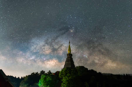 The Milky Way Galaxy moving over a sacred temple at Doi Inthanon National Park, Chiang Mai, Thailand. Night lapse from night to day. Starry night.の写真素材