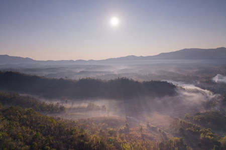 Fog in the morning forest with green mountains. Pang Puai, Mae Moh, Lampang, Thailand.の写真素材