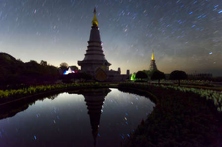 Star trails moving over a sacred temple at Doi Inthanon National Park, Chiang Mai, Thailand.の写真素材
