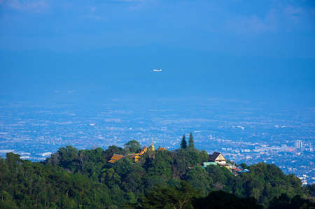 Viewpoint of Phra That Doi Suthep in the morning. Airplane flying over and Chiang Mai city view with lens flare, Chiang Mai, Thailand.の写真素材