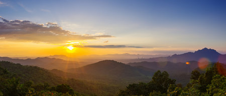 Beautiful  panorama landscape sunset over peak Mountain with warm light Mae Moh  Lampang, Thailand.の写真素材