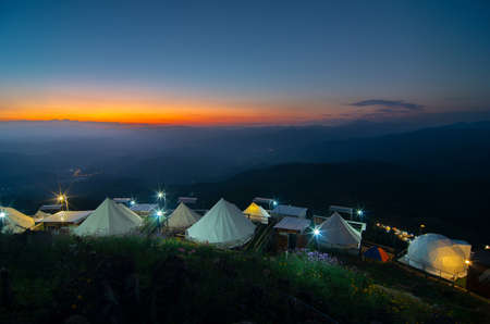 Mon Chaem Viewpoint Evening sunset among mountains and beautiful natural scenery and resort, accommodation, tent with lens flare, Chiang Mai, Thailand.の写真素材