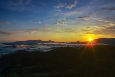 Aerial view Beautiful  panorama of morning scenery Golden light sunrise And the mist flows on high mountains forest. Pang Puai, Mae Moh, Lampang, Thailand.の写真素材
