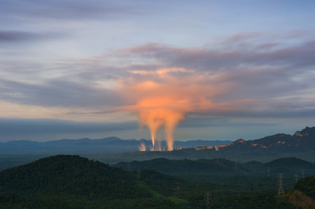 Beautiful sea of fog in the mountains, high voltage pole and steam from the coal power plant in the morning sunrise . Mae moh, Lampang, Thailand. Energy and environment concept .の写真素材
