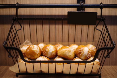 Bread buns in a black basket.の写真素材
