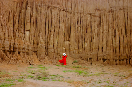 Women and landscape of soil textures eroded sandstone pillars, columns and cliffs, natural erosion of water and wind, Sao Din Na Noi, Hom Chom, Khok Suea at sri nan national park in Nan Province.の写真素材