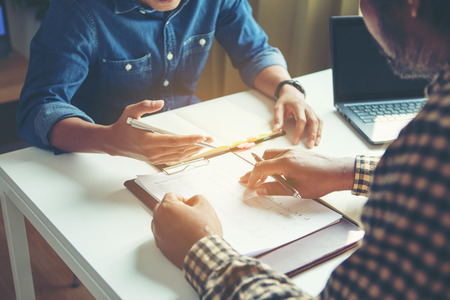 Business people analyzing financial figures denoting the progress in the work of the companyの写真素材