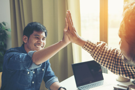 Businessman giving high five to his partner on meetingの写真素材